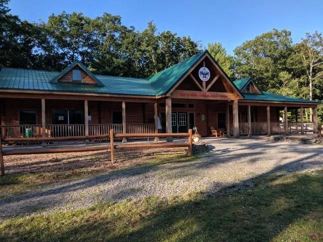 A log lodge with a green roof at a Scout camp