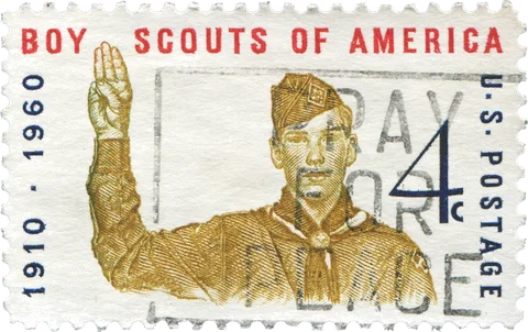 A 1960 U.S. postage stamp marking 50 years of Scouting, showing a Scout giving the Scout sign